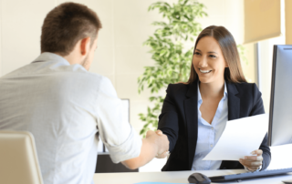 Two young professionals shaking hands in a job interview in Clarksville, TN