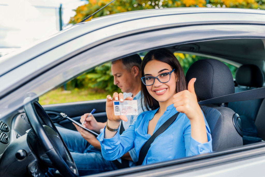 A young woman driving a car with an instructor as part of Drivers ed classes in Tennessee.