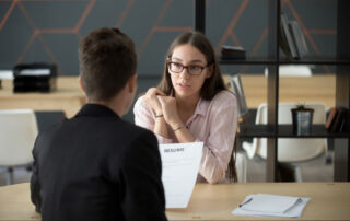 Woman showing her resume during an interview