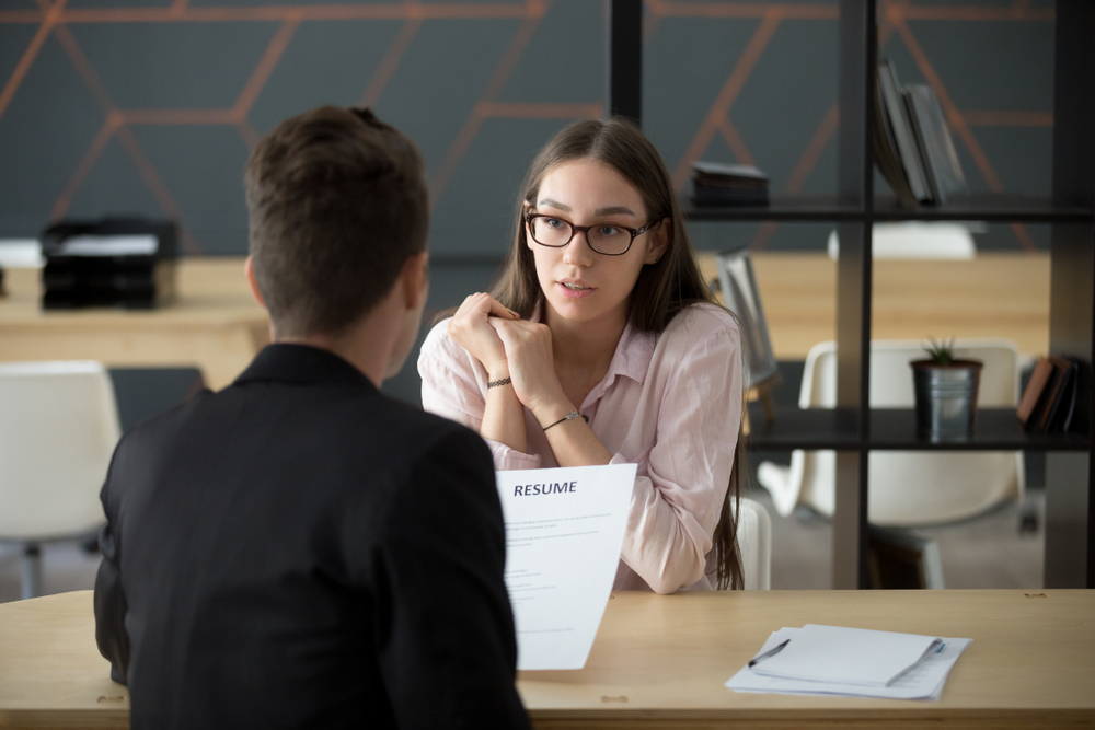 Woman showing her resume during an interview