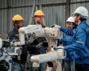 A man teaching his team about a new piece of technology.