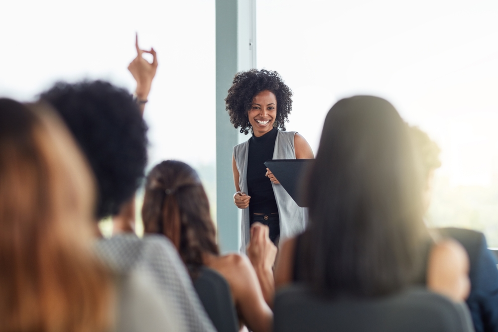 A woman leading a seminar and taking questions