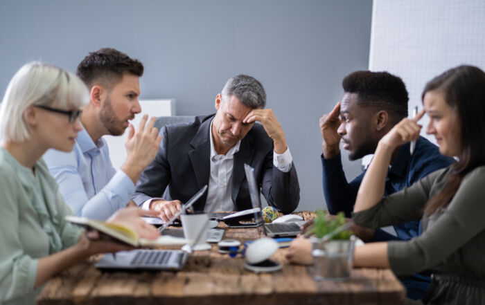 A group of coworkers stressed about a conflict.