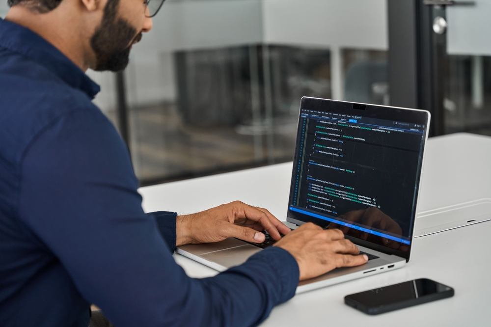 A man working on code on his computer.