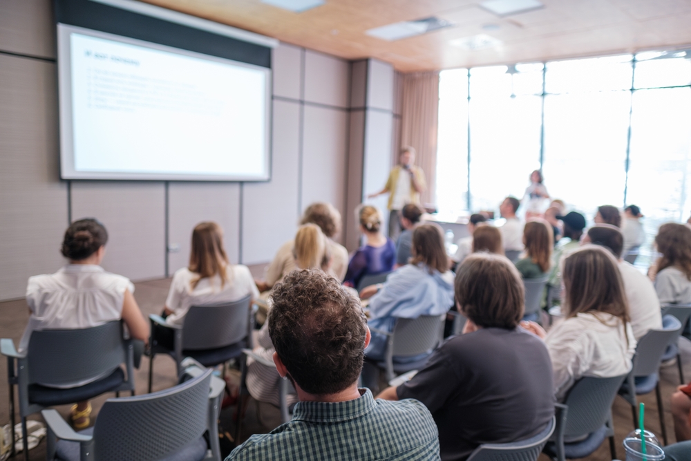 A classroom of people learning from an instructor.