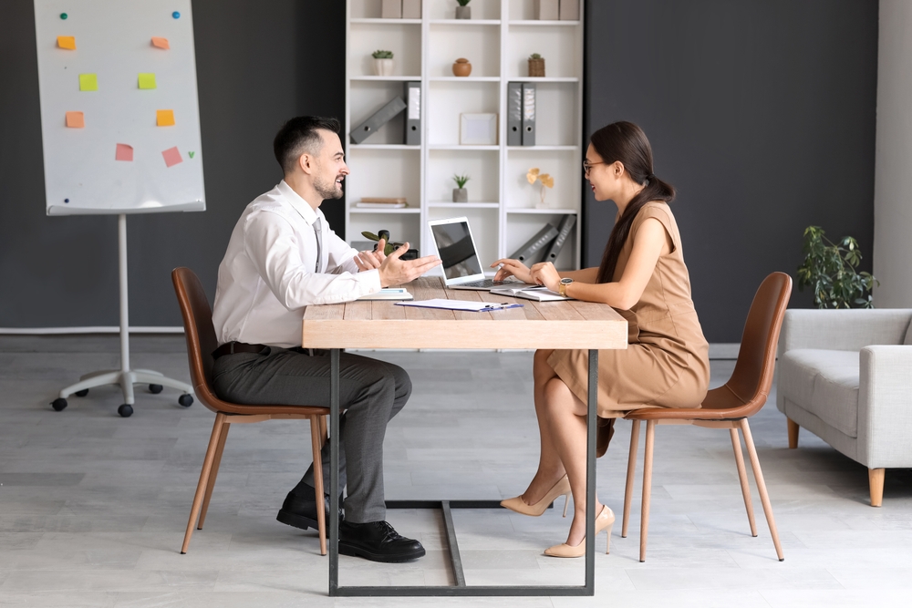 A man and woman sitting down for an interview