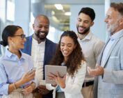 Diverse group of business professionals collaborating with a mentor in an office